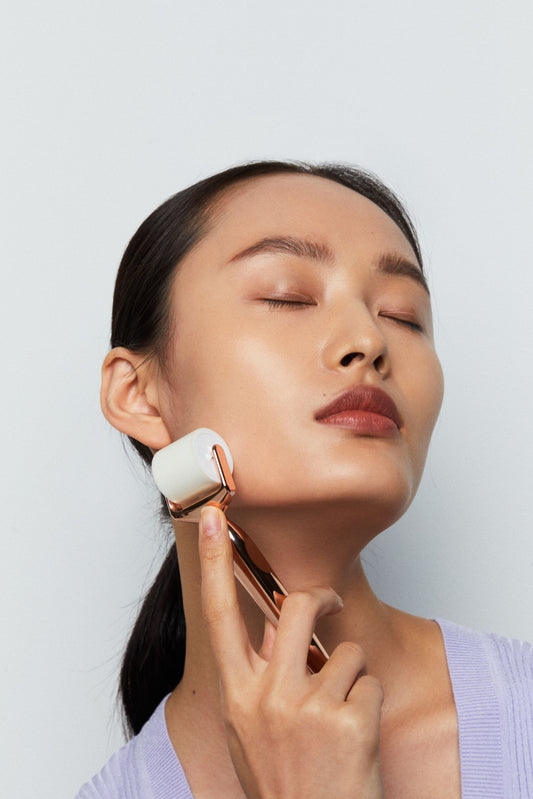 Image of a Asian Woman rolling NAIIAN Beauty's Microneedle Derma Roller on her jawline